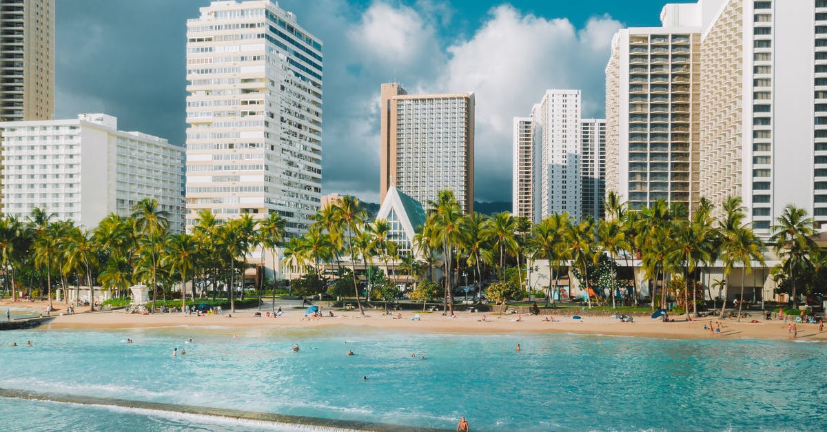 Hotels cancellation policy J-2, J-25, etc - People on Beach Near High Rise Buildings