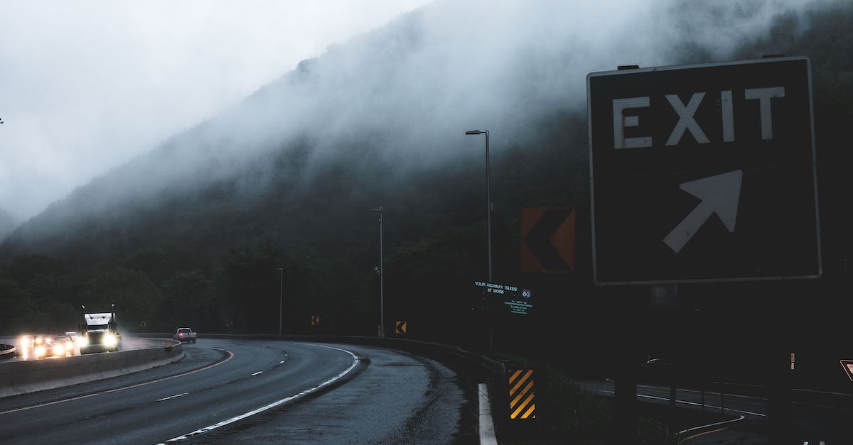 How's the weather for hiking in lower Tibet in May? - Black and White Exit Signage on Roadside