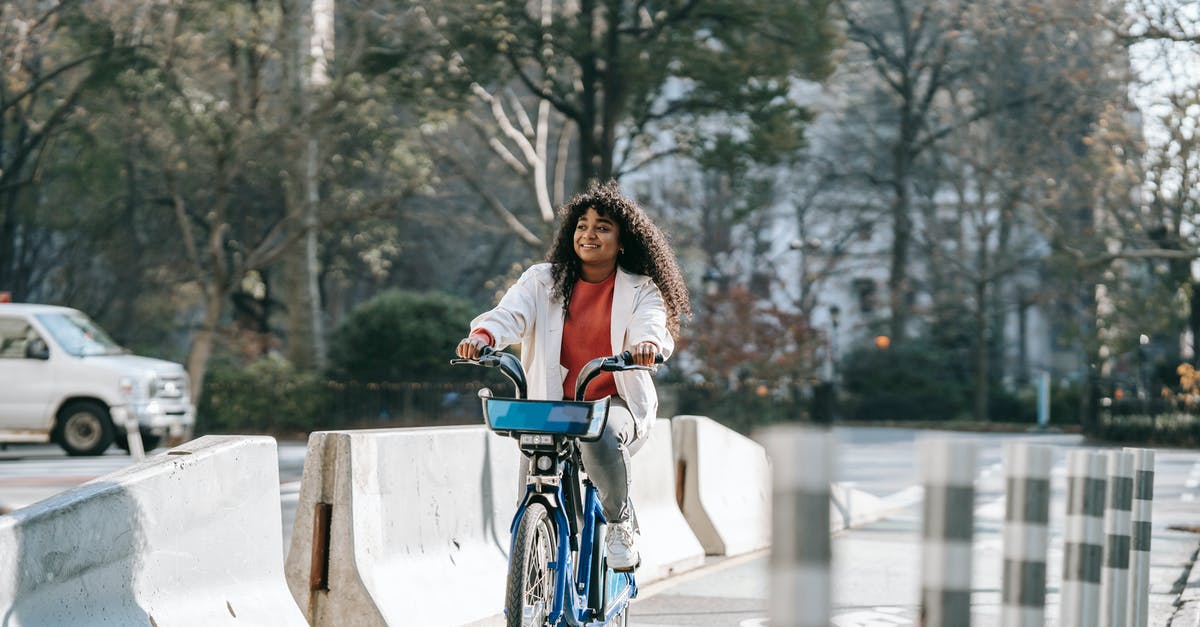 How bad is the rainy season in the Peru highlands? - Cheerful black woman riding bicycle on city street