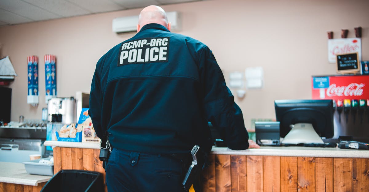 How big is "too big" for an airline seat? At what point will you be required to buy two tickets? - Police Man Standing Infront Of A Counter In A Restaurant
