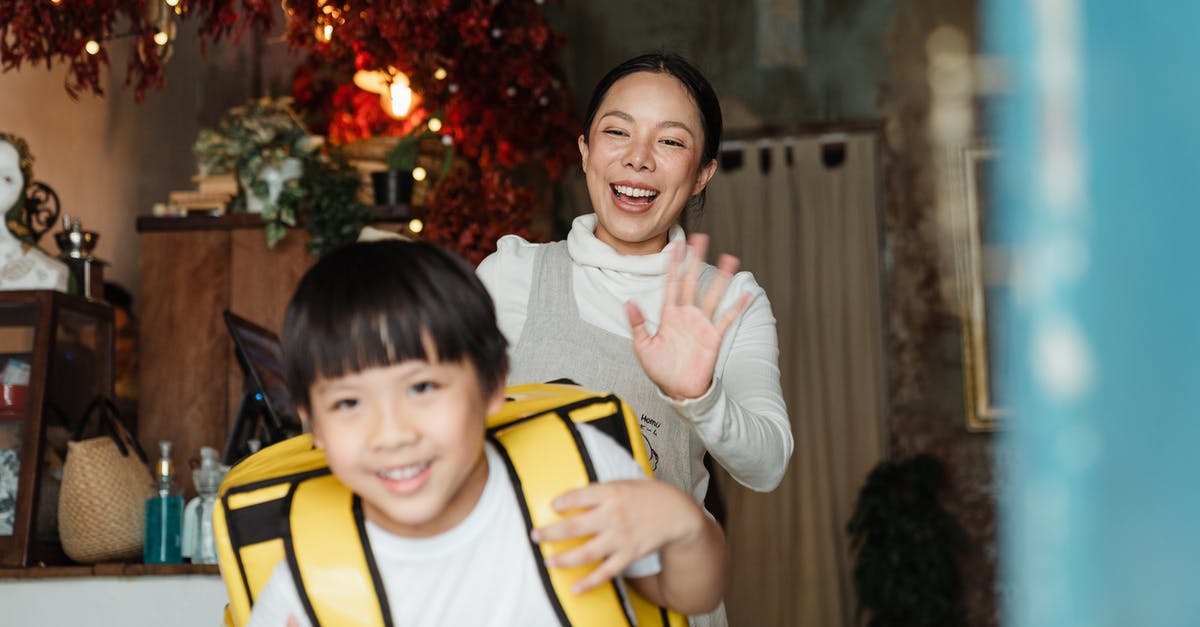 How big of a backpack should I buy? (Trans-Mongolian) - Cheerful ethnic mother saying goodbye to son with food backpack