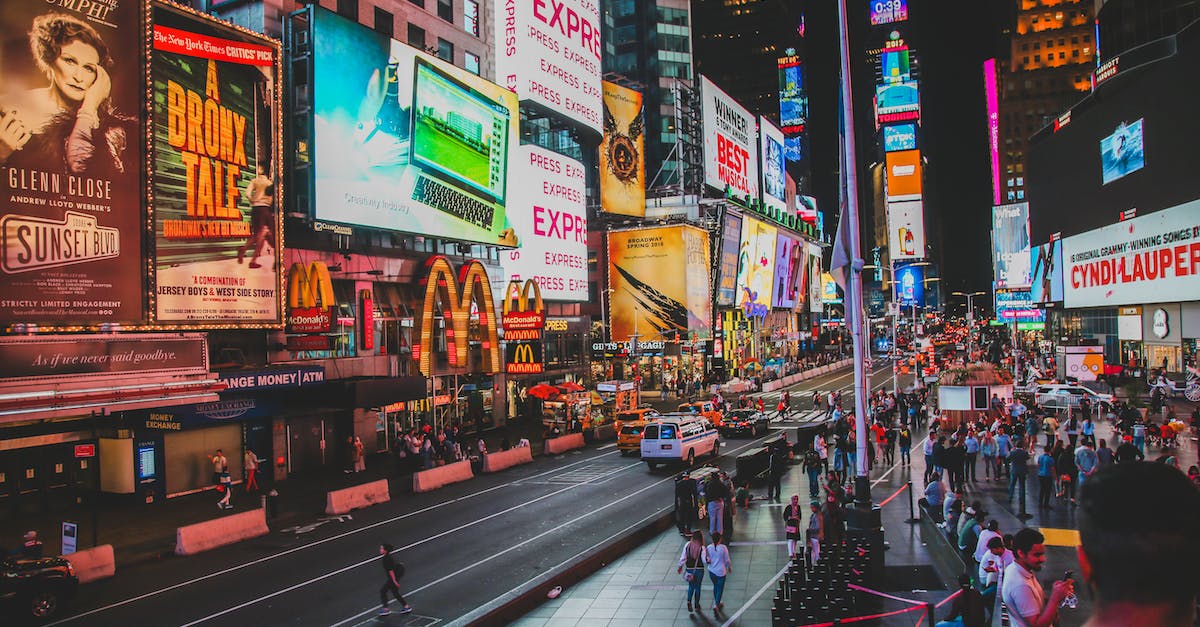 How busy is New York City on New Year's Eve? - People Walking on Sidewalk Near Buildings during Night Time