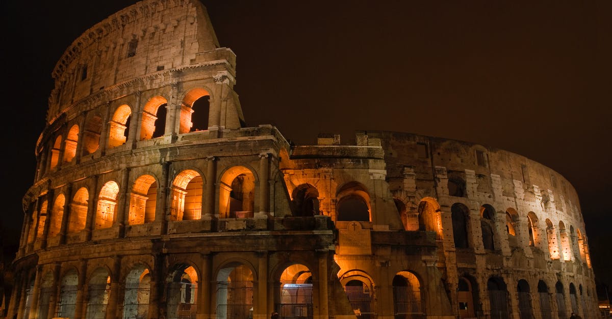 How busy is the Roman Colosseum throughout the year? - Ancient Concrete Building Under Cloudy Sky