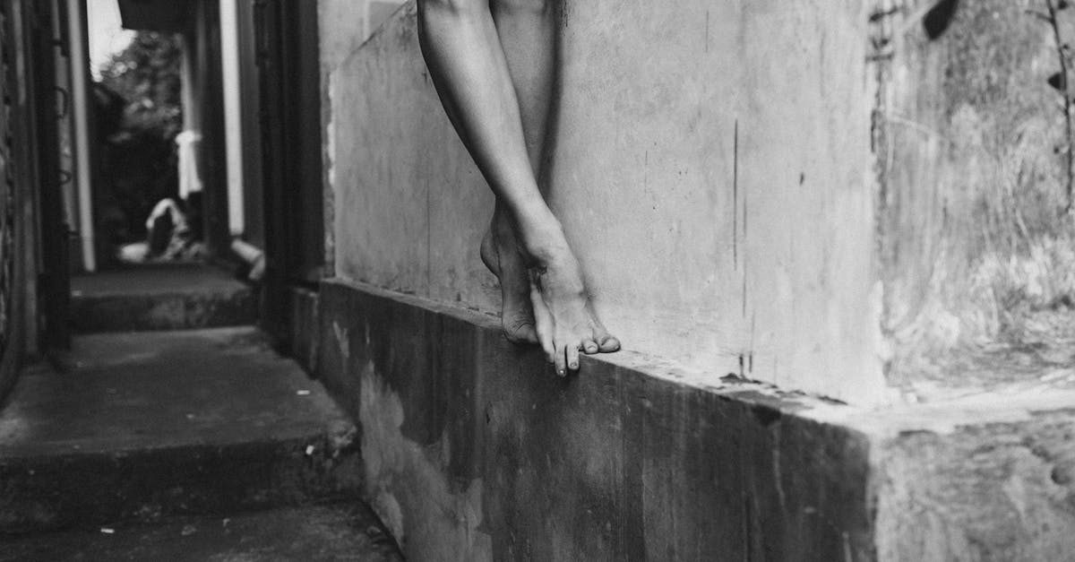 How can a tourist obtain an 'authentic' duelling scar? - Crop woman standing on wall border of building