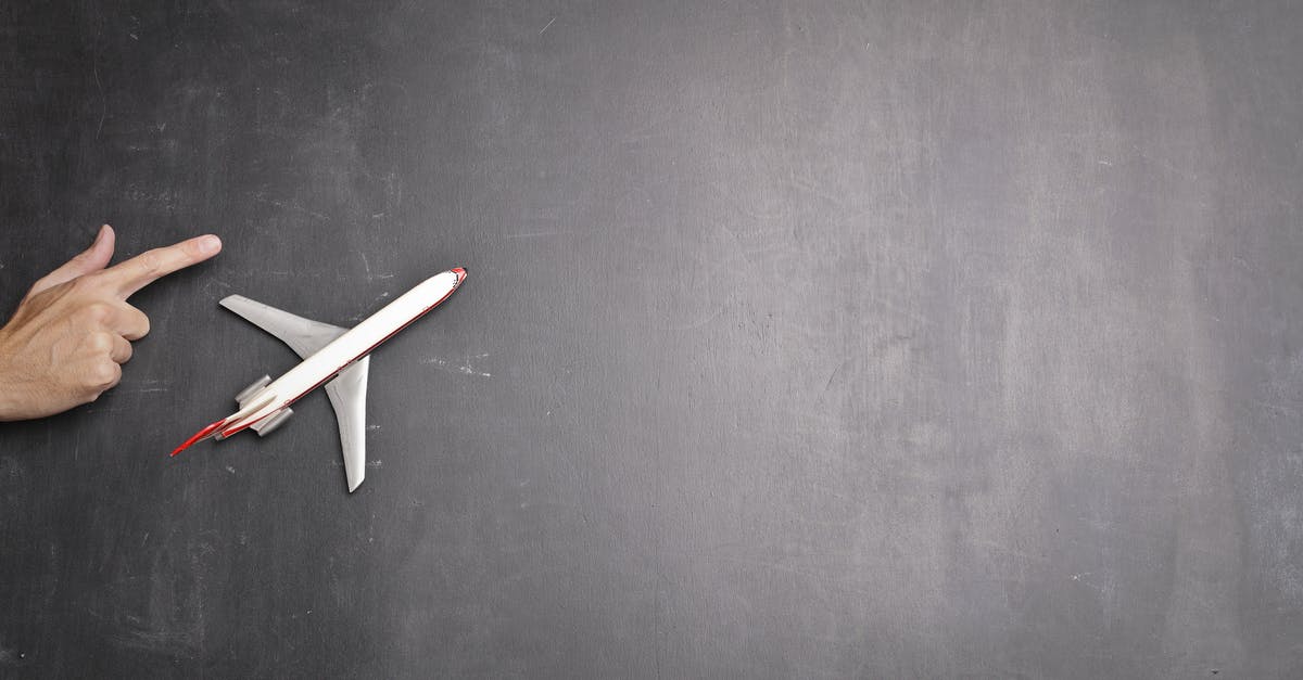 How can I avoid or minimize jet lag on flights? - Toy plane and human hand on chalkboard