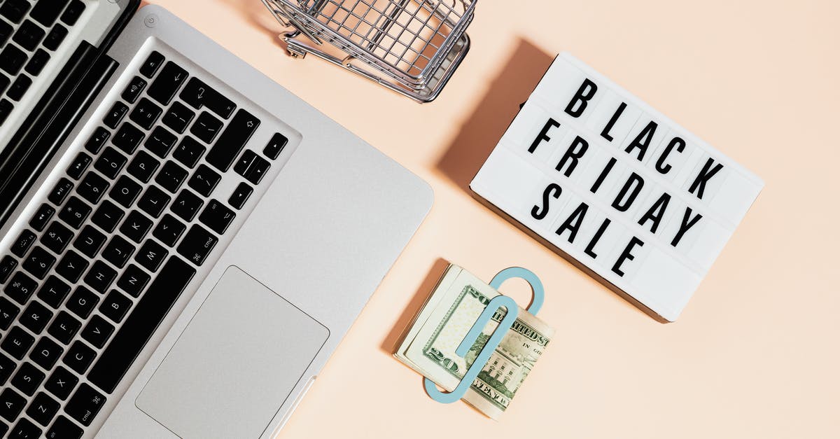 How can I buy groceries during a mandatory 14 day quarantine? - Top View of Silver Macbook Beside a Shopping Cart and Black Friday Sale Signage