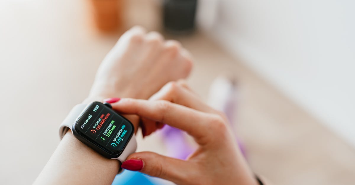 How can I check the status of an Australian visa application? - Faceless woman checking smartwatch and sitting on mat