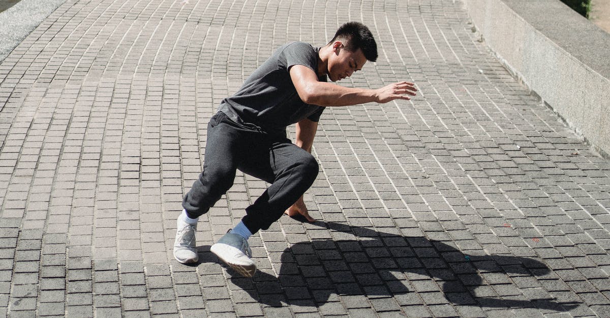 How can I determine if I need an International Driving Permit? - Energetic Asian man dancing street dance on sidewalk