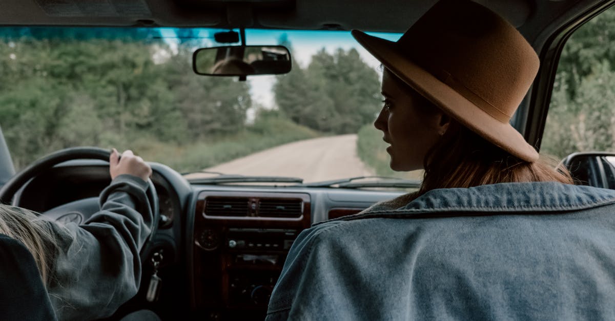 How can I get an elevation profile of a driving route - Man in Brown Cowboy Hat Driving Car