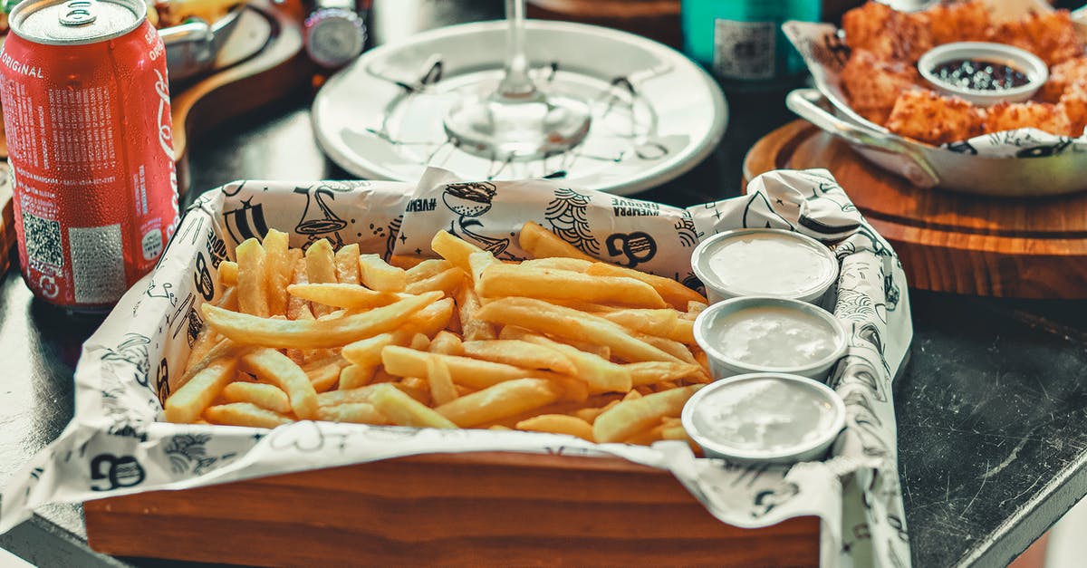 How can I get to Cacao, French Guiana? - A Fries with Dips on a Wooden Tray Near the Red Can