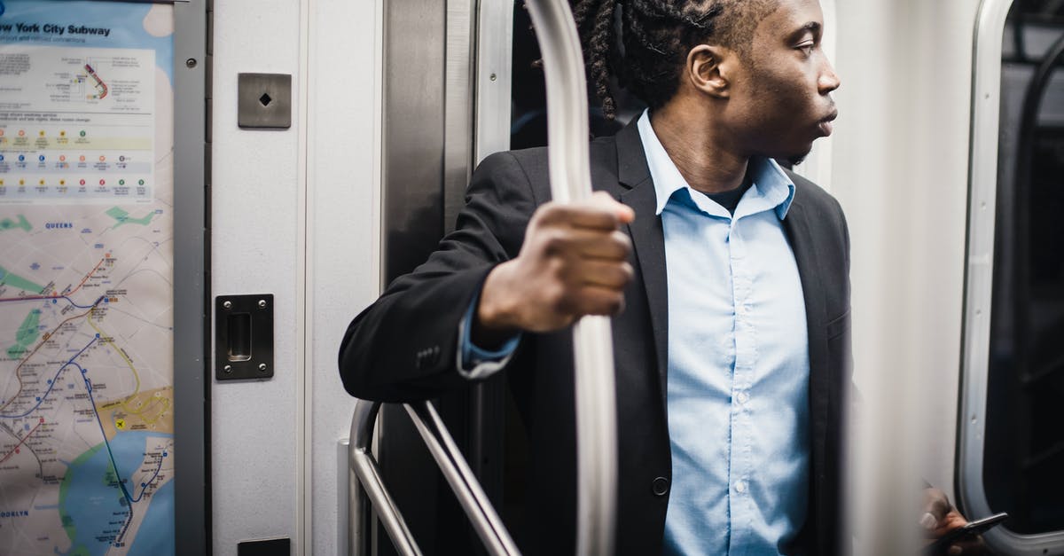 How can I go to Perperikon by public transport? - Male passenger in formal wear getting home by train