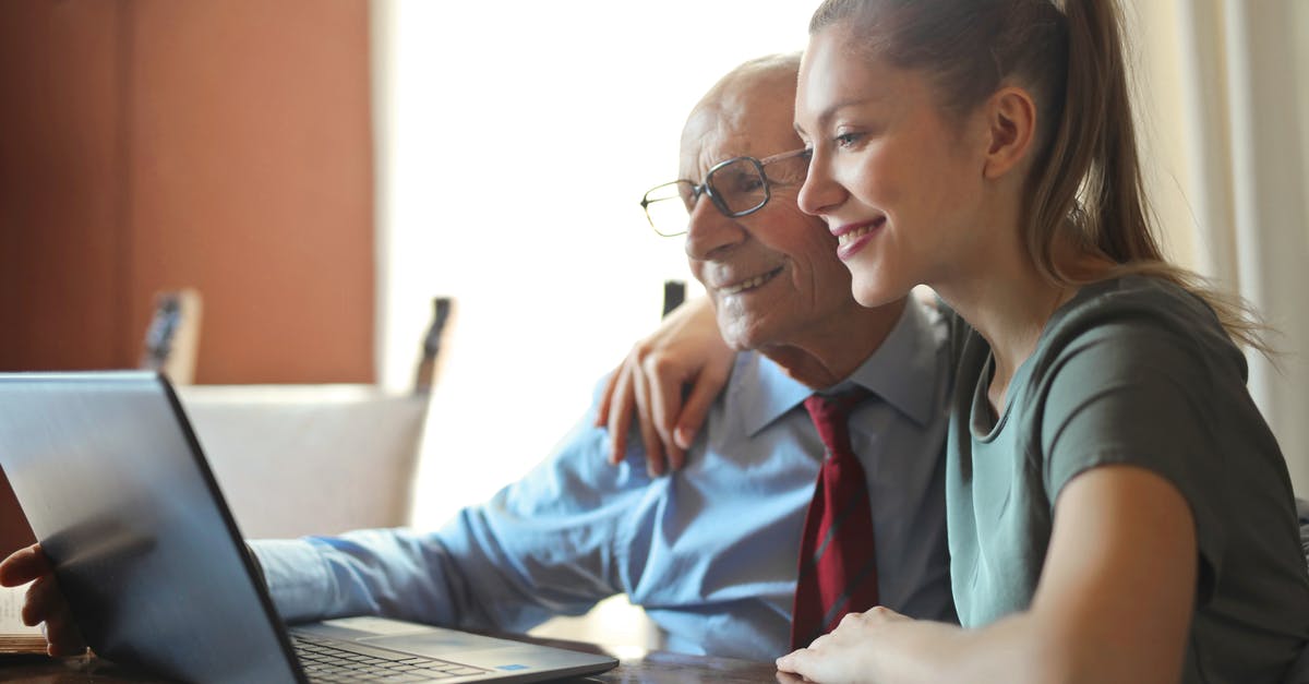 How can I help Japanese speakers using my hard-to-pronounce name? - Young positive woman helping senior man using laptop