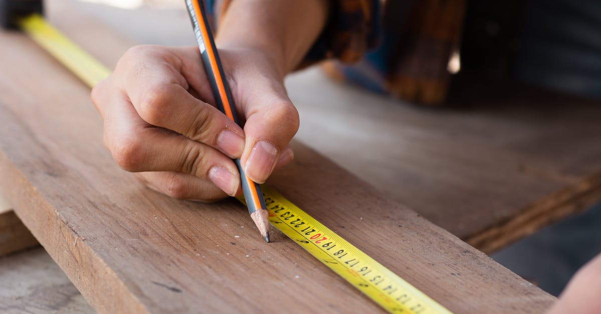 How can I measure and log the amount of radiation while being on a plane? - Woman Measuring with Yellow Pencil on Board