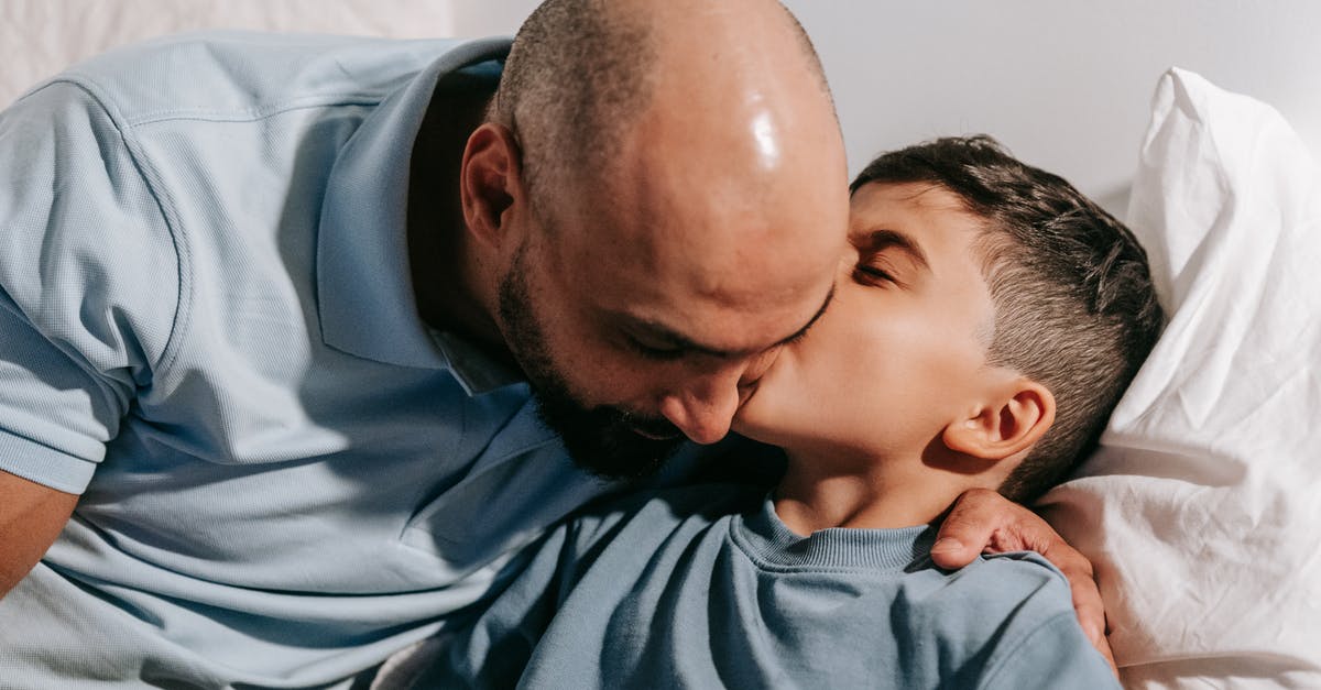 How can my father stay with me in the UK? [closed] - Man in Blue Shirt Carrying Baby