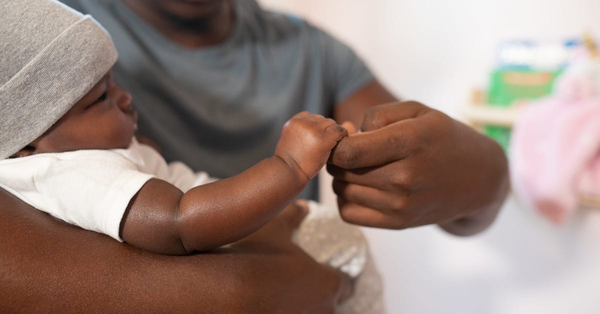 How can my father stay with me in the UK? [closed] - Shallow Focus Photo of Man Carrying His Baby