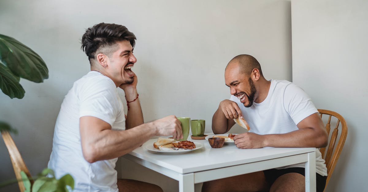 How can two airlines have the same IATA code? - Two Friends Sitting at Table and Having Fun at Breakfast