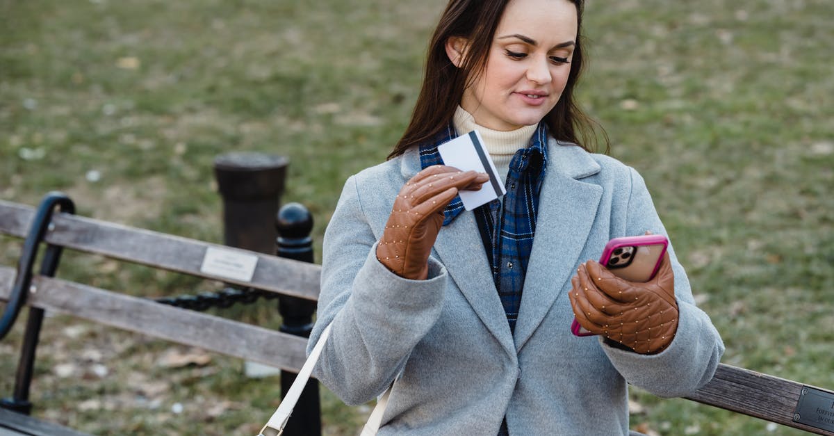 How can we pay the Canada visa application fee after the first payment failed? - Glad woman making online payment via smartphone in spring park