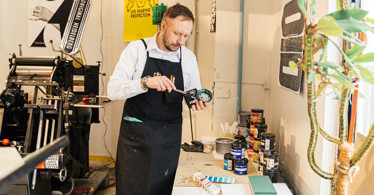 How can you quickly get accustomed to foreign coins? - A Man Standing with a Can of Paint