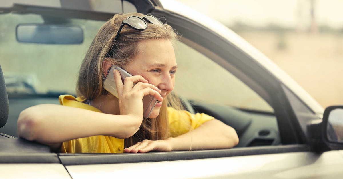 How do I avoid conversation with strangers while traveling? - Blonde-haired Woman in Yellow T-shirt Wearing Black Sunglasses Holding Silver Smartphone