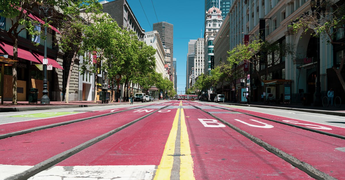 How do I book a one-way rail ticket from Tokyo to Toyota City? - Empty street with tram rails