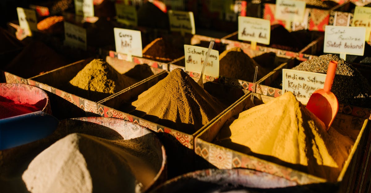 How do I choose a travel agency to book tours from in Hanoi, Vietnam? - Traditional market stall with various aromatic spices