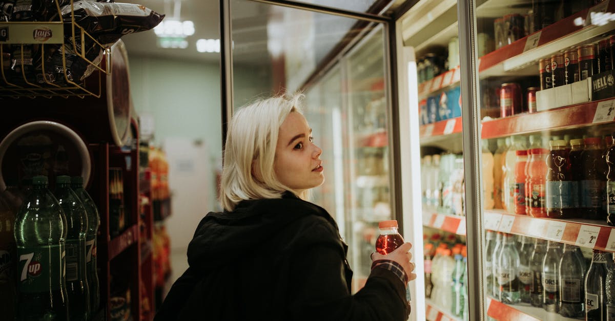 How do I get compensation for a delayed flight? - Woman Buying a Drink