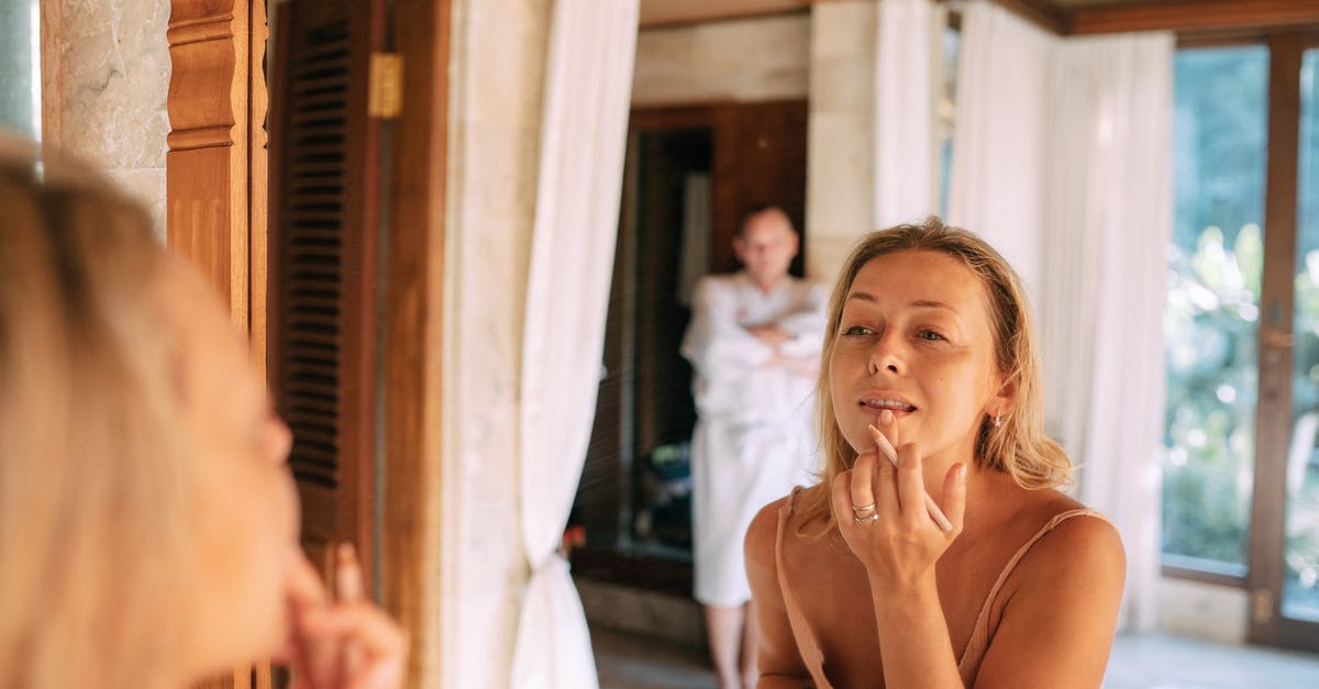 How do I get compensation for a delayed flight? - Woman Getting Ready and Doing Her Makeup 