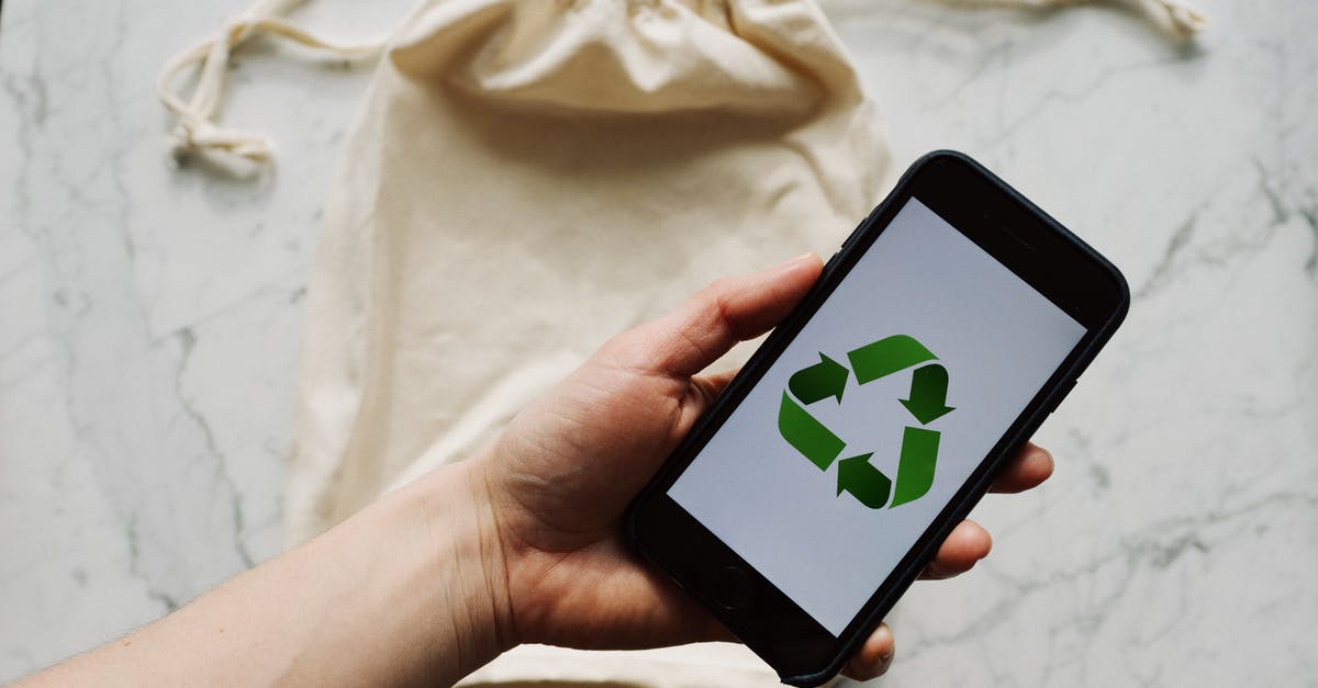 How do I prevent damage to electronic devices at airport security? - Faceless person showing recycle symbol on mobile phone screen How do I prevent damage to electronic devices at airport security? - Faceless person showing recycle symbol on mobile phone screen
