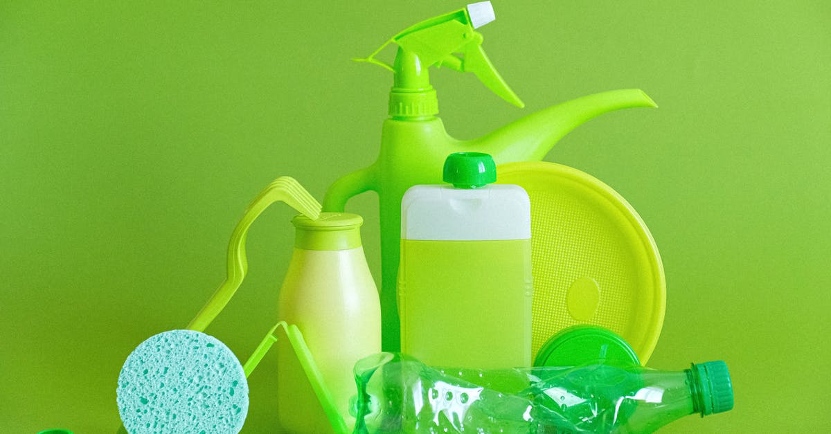 How do I prevent damage to my luggage? - Monochrome green bottles and containers for liquids or gel with plastic bottle and lids on green background