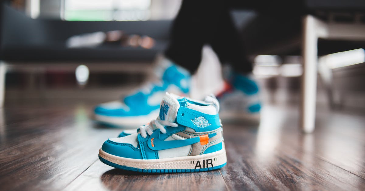 How do I rent a small bus in Buenos Aires? [closed] - Tiny vibrant sneakers for baby on wooden floor in bright room in daylight on blurred background