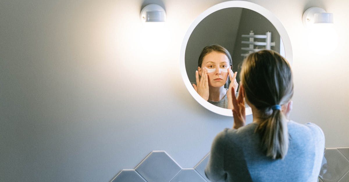 How do I update my family application for a B1/B2? - Woman in Gray Long Sleeve Shirt Standing Beside Mirror