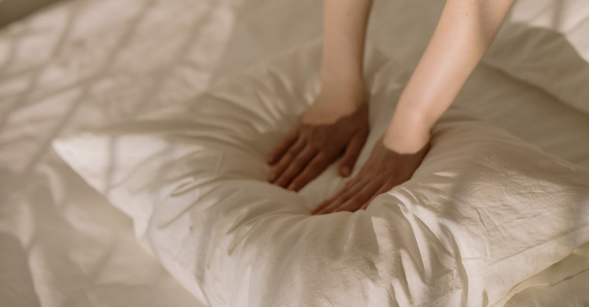 How do stained bedclothes affect the nightly price? [closed] - Woman in White Dress Lying on Bed