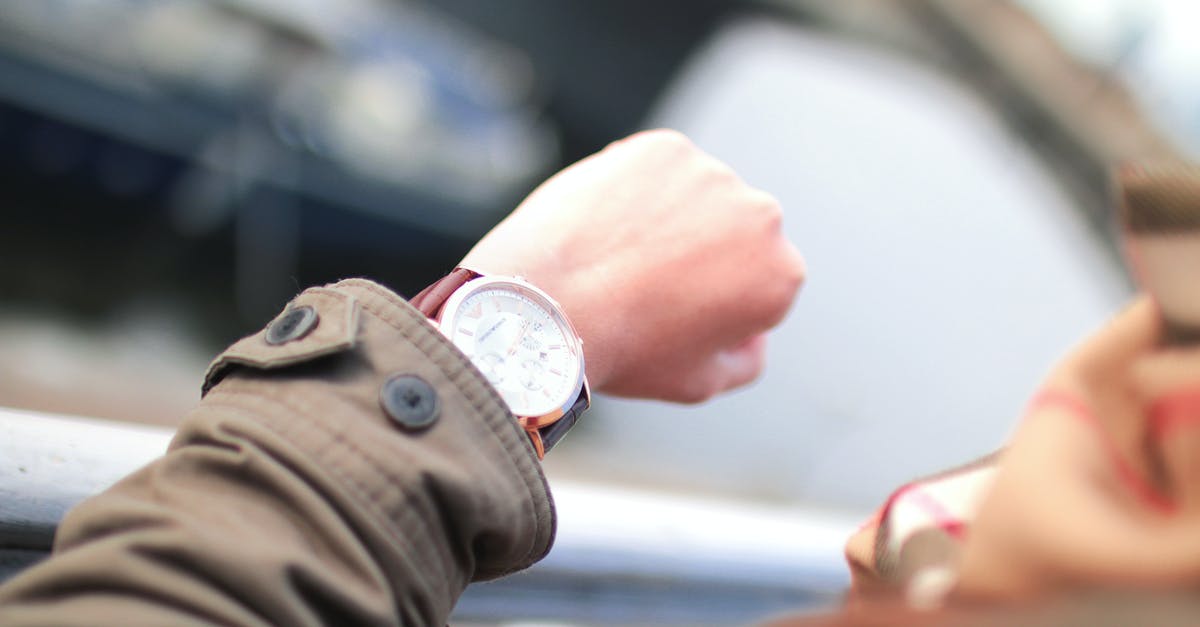 How do taxis in Bangkok charge for waiting time? - Selective Focus Photography of Person Watching Watch