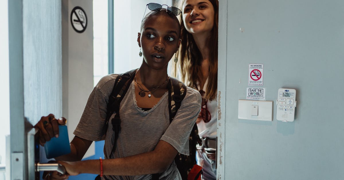 How do you 'self-isolate' in a hostel dorm room? - Woman in Gray Crew Neck Shirt Standing Beside Woman in Gray Crew Neck Shirt