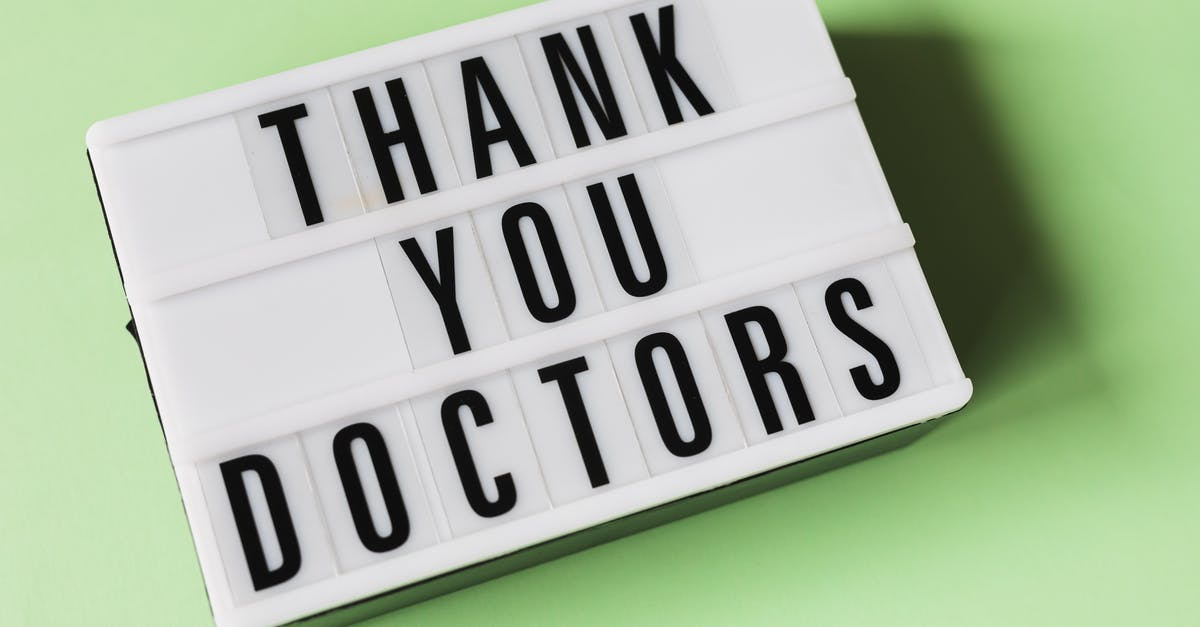 How do you check in to a campground? - From above of vintage light box with THANK YOU DOCTORS gratitude message placed on green surface