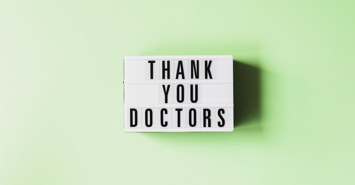 How do you check in to a campground? - Top view of retro light box with THANK YOU DOCTORS inscription placed on green surface