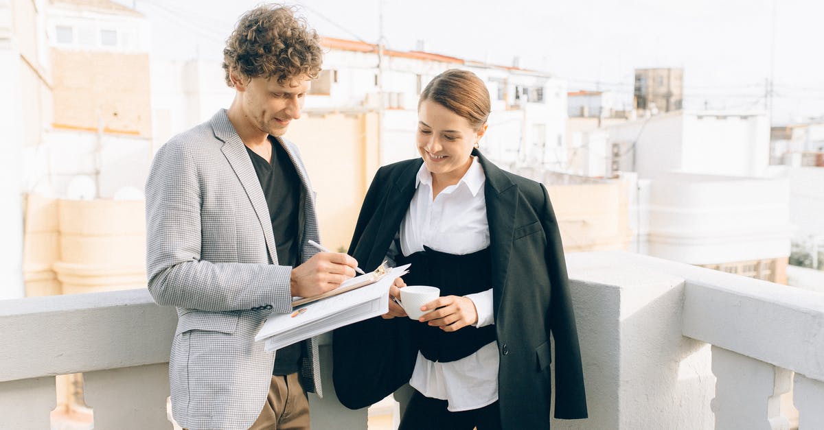 How do you declare independent consulting income for schengen visa? - Woman in Gray Blazer Holding Book Beside Woman in Black Blazer