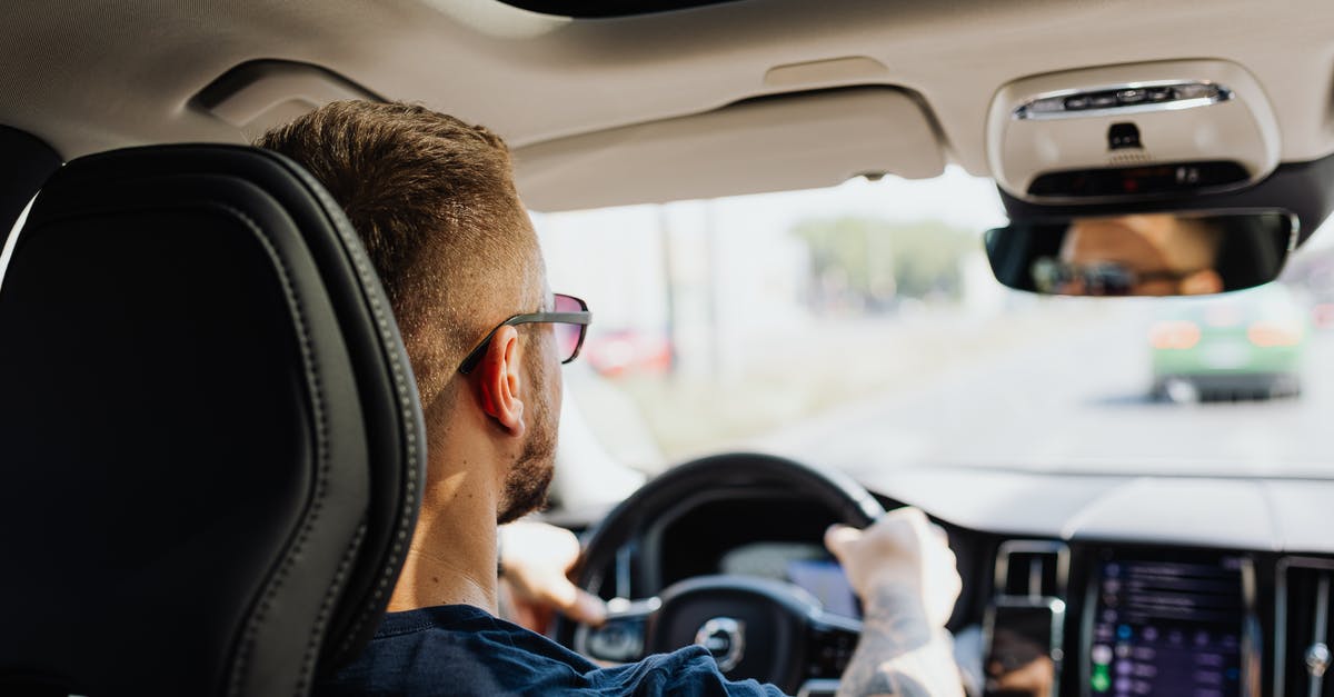 How do you drive from Asia to Europe? [closed] - Man in Blue Jacket Driving Car