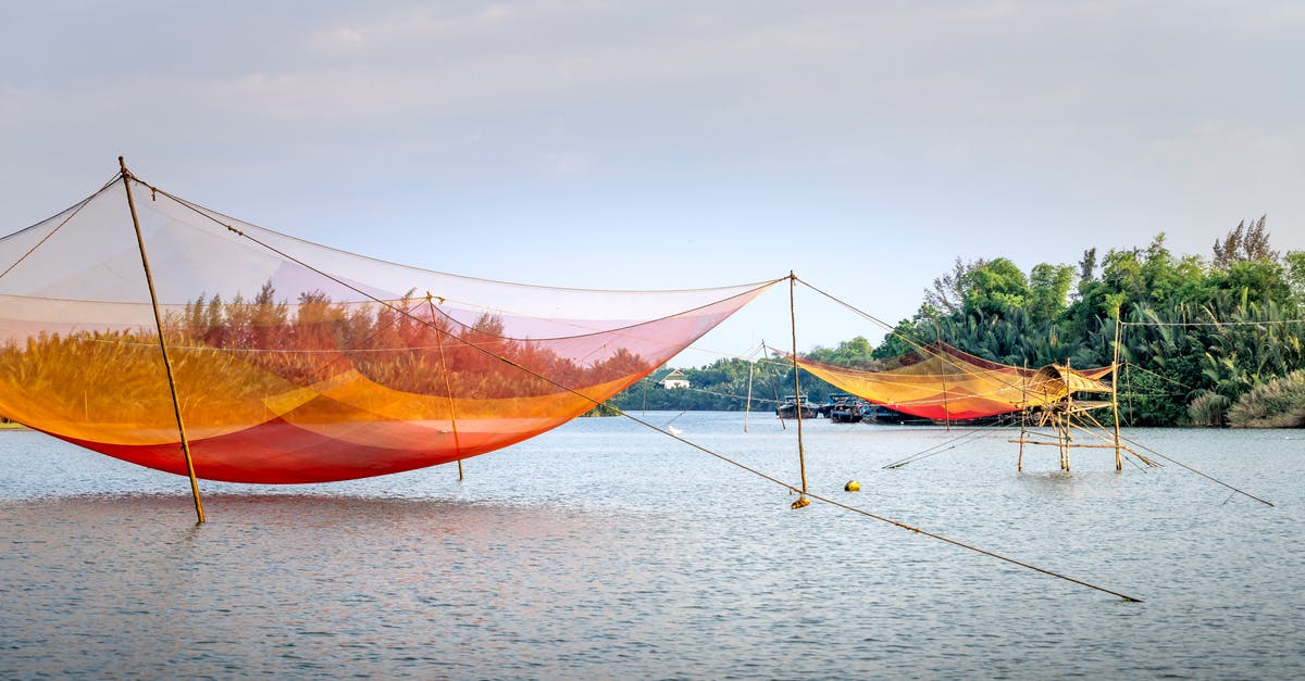 How do you find quiet and well-equipped places to work in cities when travelling? - Fishing nets over water at daytime