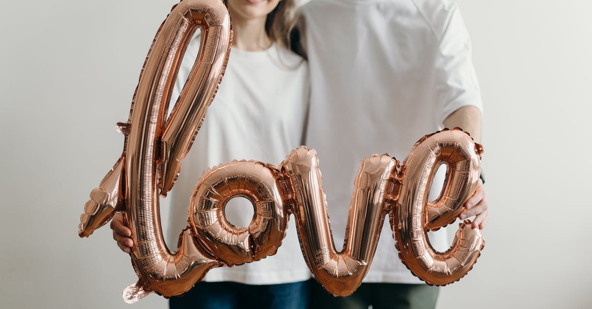 How do you get air miles? - Man in White Crew Neck T-shirt Holding Brown and White Heart Shaped Ring