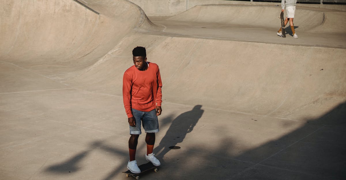 How does jetBlue determine its boarding order? - Active young male skateboarder riding skateboard on asphalt ramp