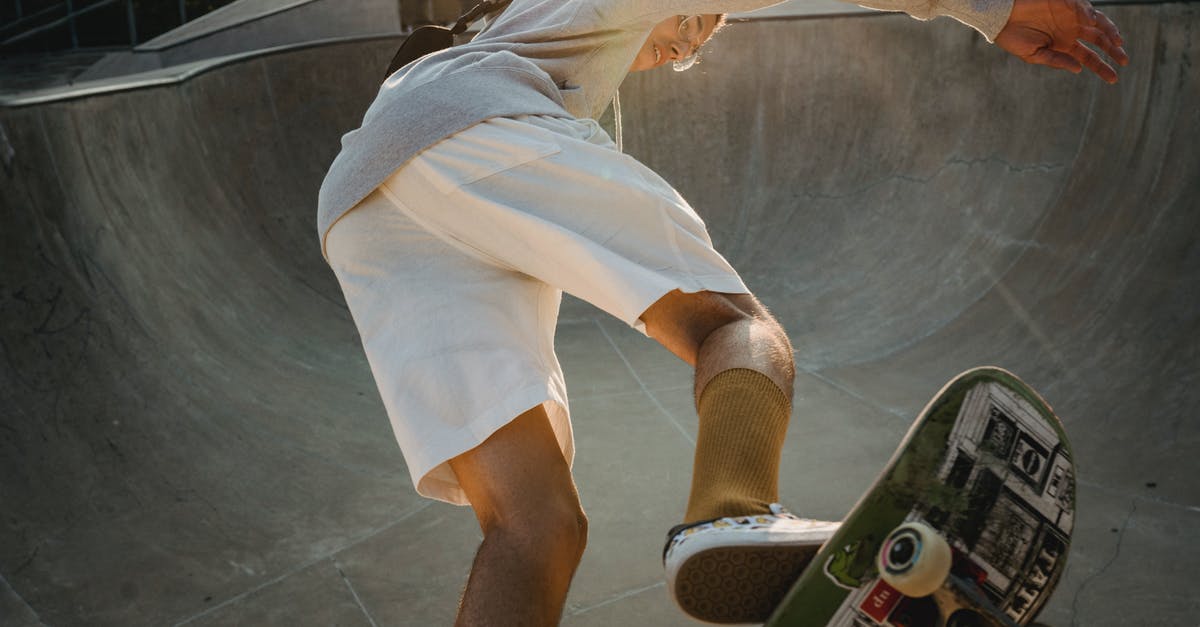 How does jetBlue determine its boarding order? - From below of young confident guy in activewear performing ollie stunt on skateboard on concrete ramp in skate park on summer sunny day