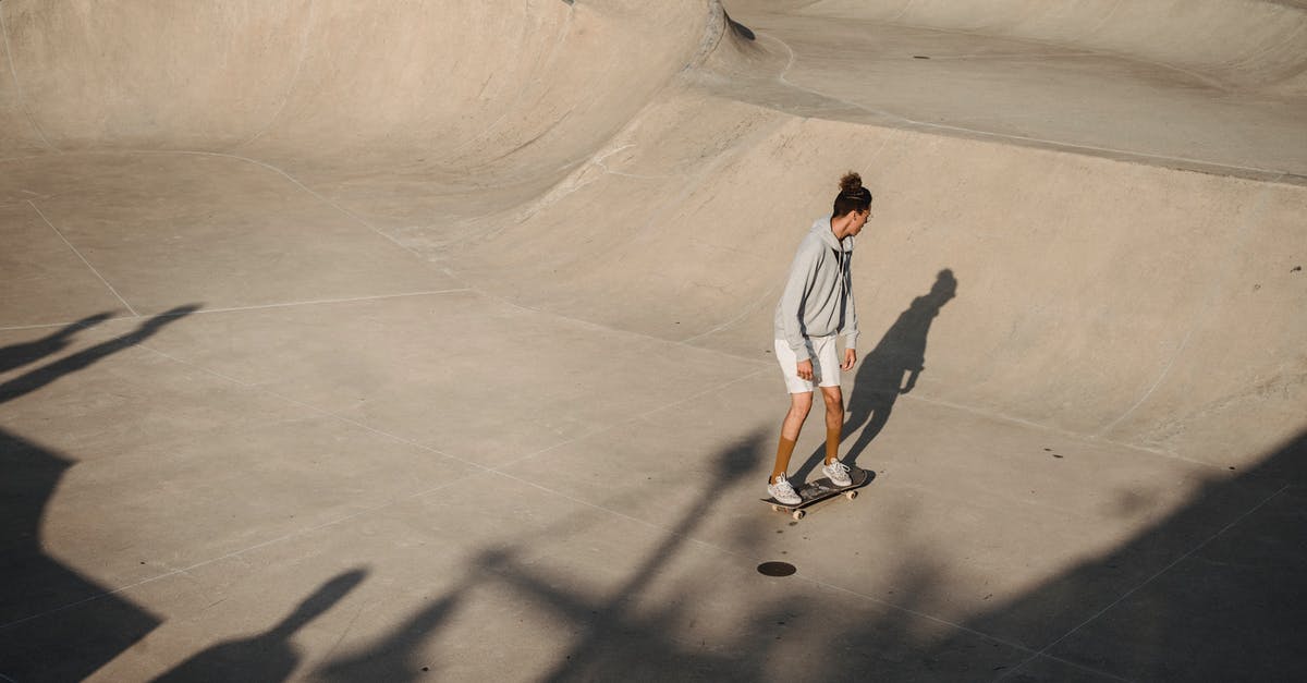 How does jetBlue determine its boarding order? - From above of anonymous young sportsman performing stunt on skateboard on asphalt ramp during outdoor training on sunny day