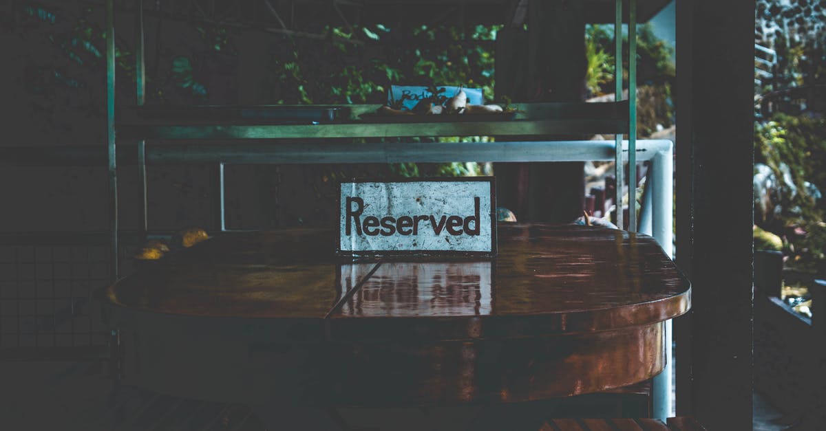 How does overbooking work with reserved seats? - White Reserved Sign on Brown Wooden Table