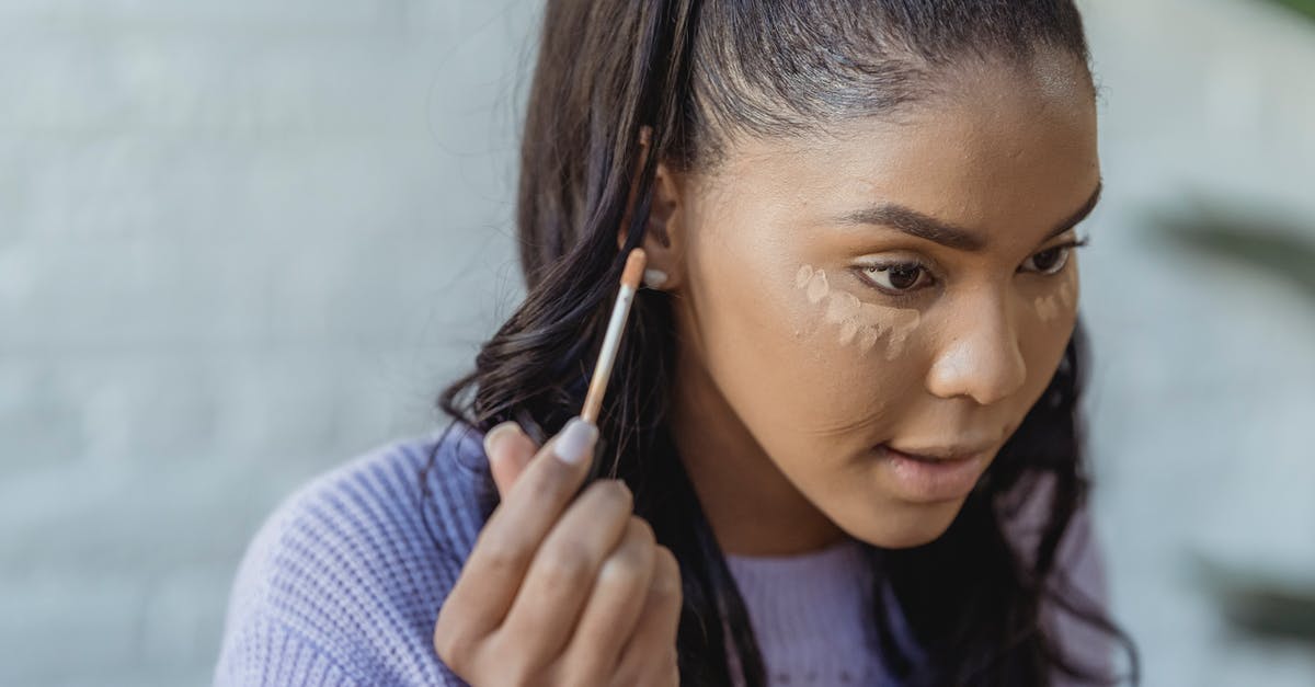 How does Schengen 90/180 apply to long-stay visas? [duplicate] - Crop African American woman with long dark hair applying concealer under eyes and looking away in light room