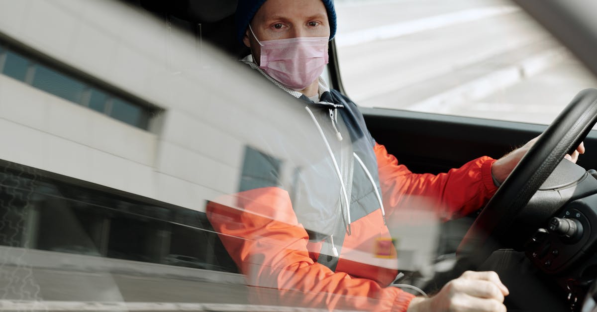 How does the CDC define an overnight stay? - Man Wearing a Face Mask Driving a Vehicle