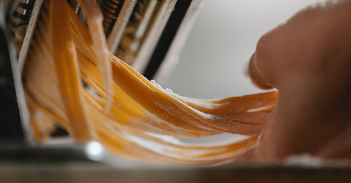 How does the Italian "Aperitivo" work? - Person cutting noodle with pasta machine