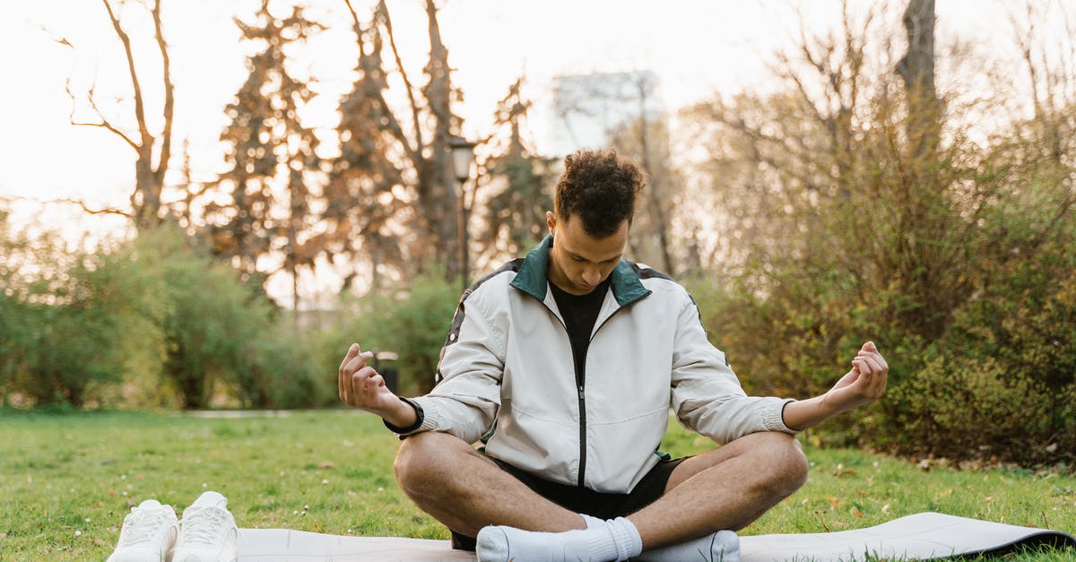 How easy is it to park in Rimini in August? - A Man Meditating at a Park