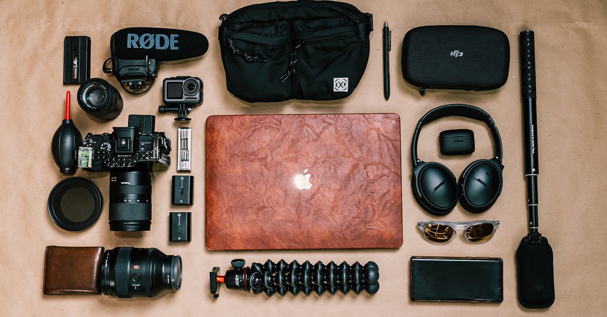 How, exactly, does the ESTA system work - specifically on arrival? - Overhead view of laptop and photo camera composed with headphones and other gadgets of professional photographer