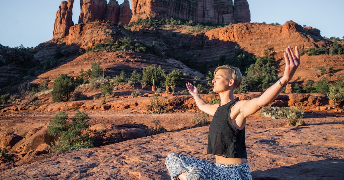 How fit does one need to be for the Grand Canyon rim-to-rim - Young slim lady in summer top and hippie pants sitting with arms spread and eyes closed on rough ground while doing yoga near magnificent sunlit canyons How fit does one need to be for the Grand Canyon rim-to-rim - Young slim lady in summer top and hippie pants sitting with arms spread and eyes closed on rough ground while doing yoga near magnificent sunlit canyons